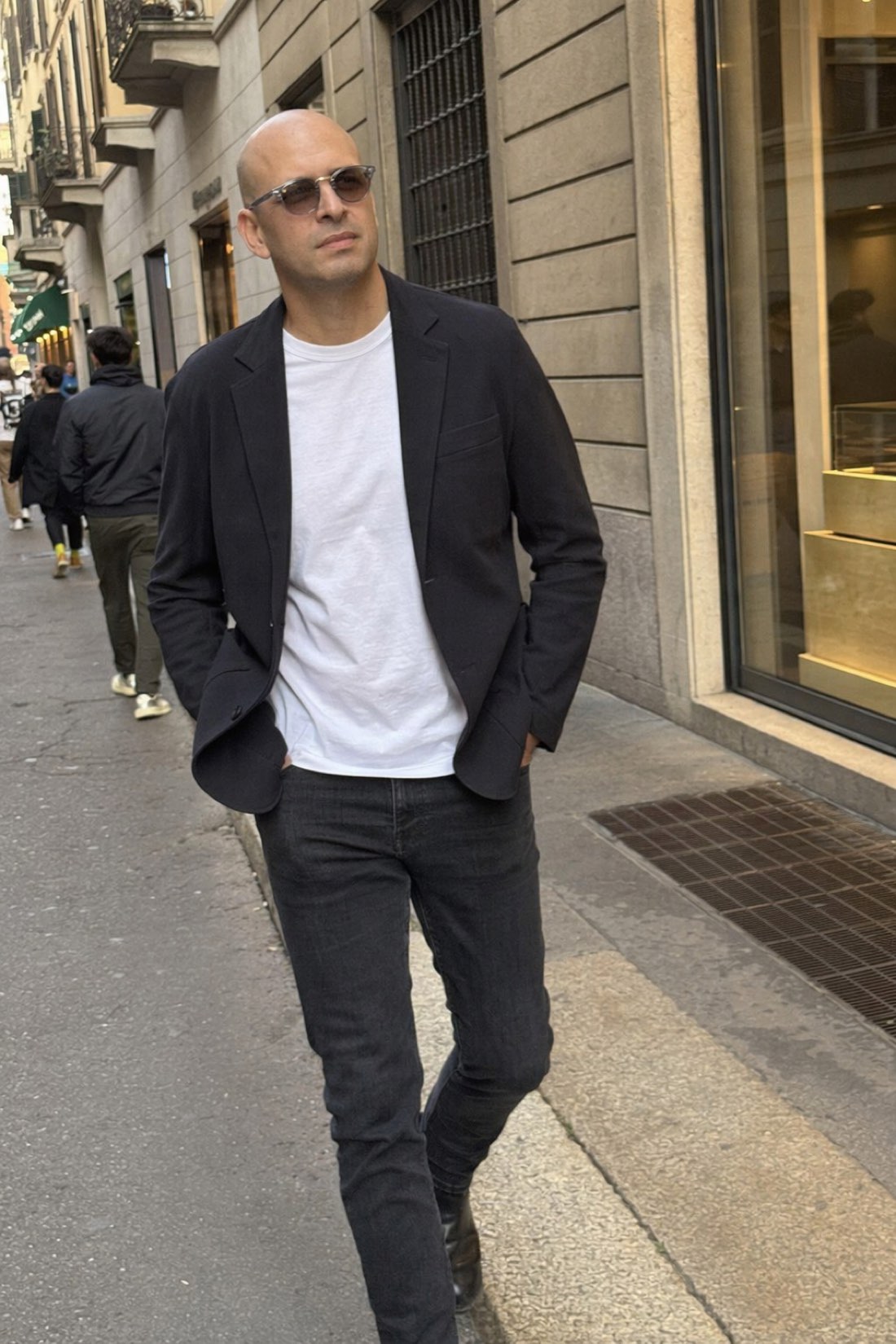 Man in a blazer on a city walk, dressed like the job without talking about the job
