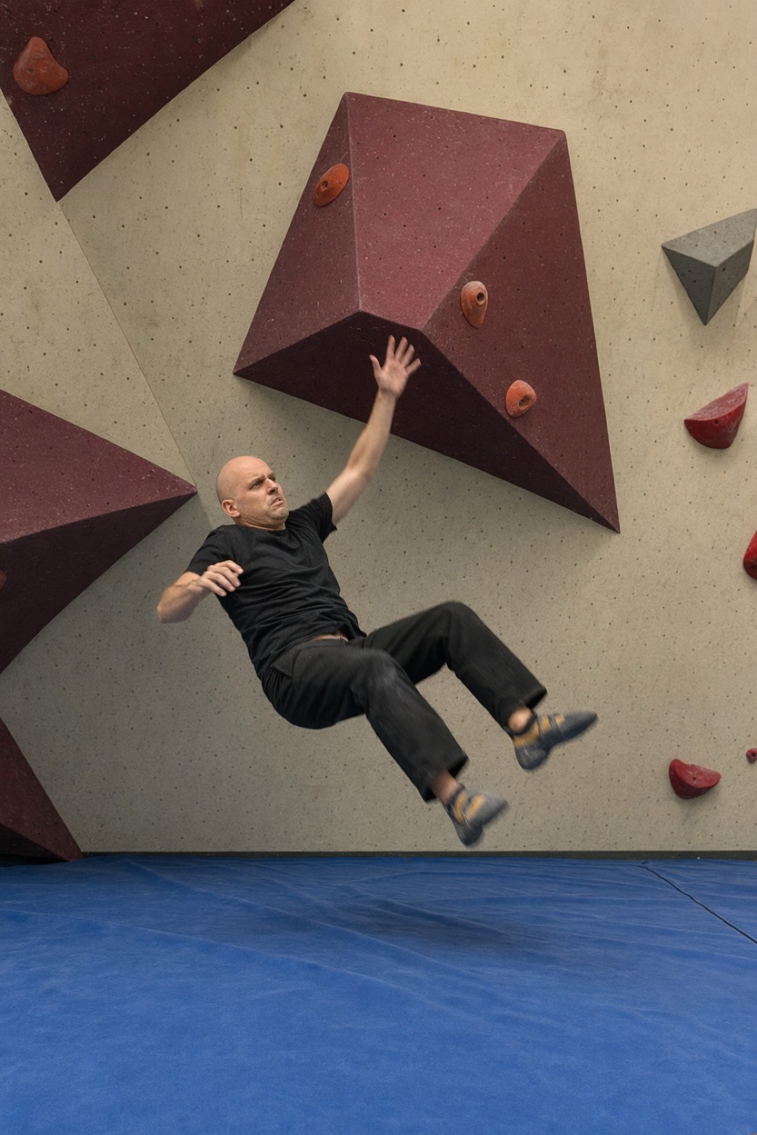 Man mid-air falling off a bouldering wall, which is still one fall further than the man who never climbed