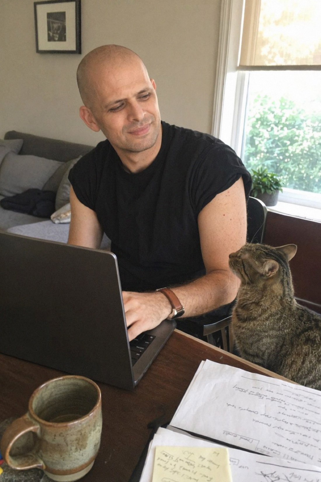 Man at home with a laptop and a cat, which is where most boring texts are written