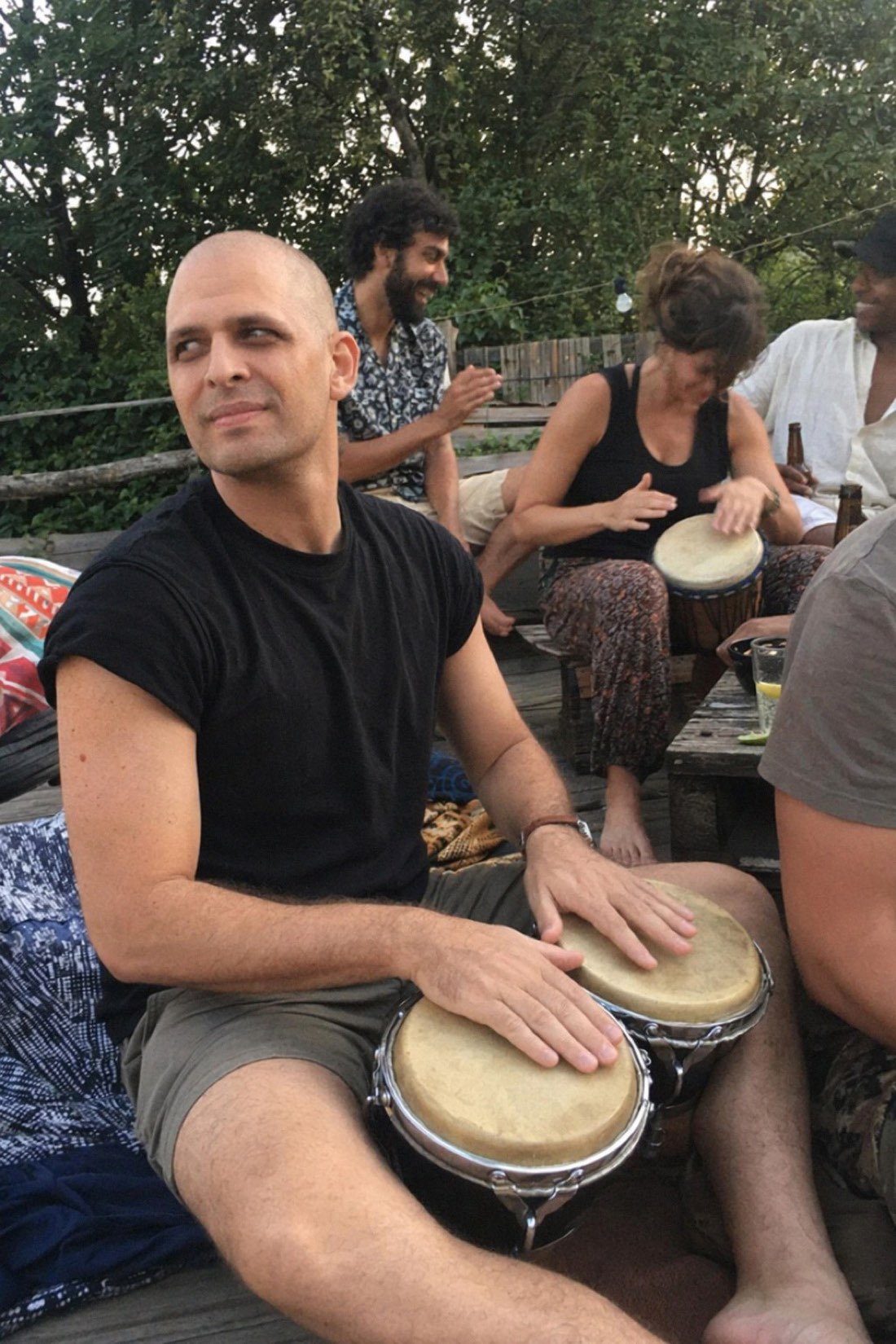 Man playing drums at an outdoor gathering