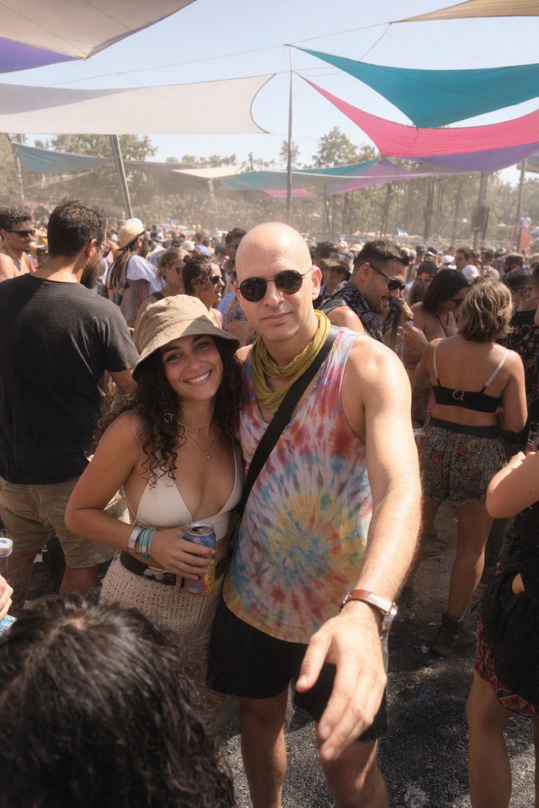 Man out with friends at a festival, thirty days into the version of himself the breakup paid for