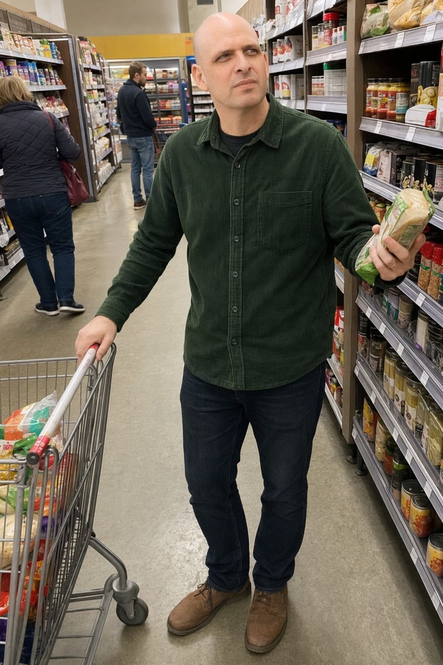 Man in a grocery aisle looking into a cart with dawning suspicion that it is not his cart
