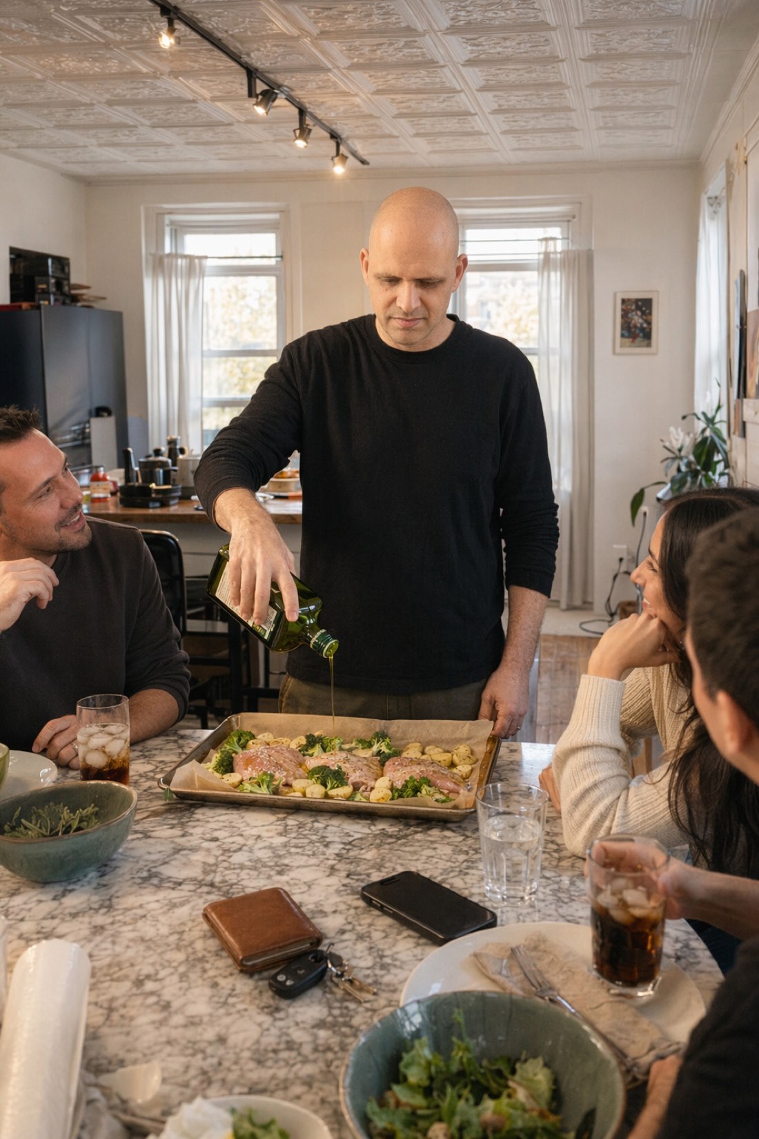 Man serving dinner to friends at home, an AI photo that preserves his real face and proportions