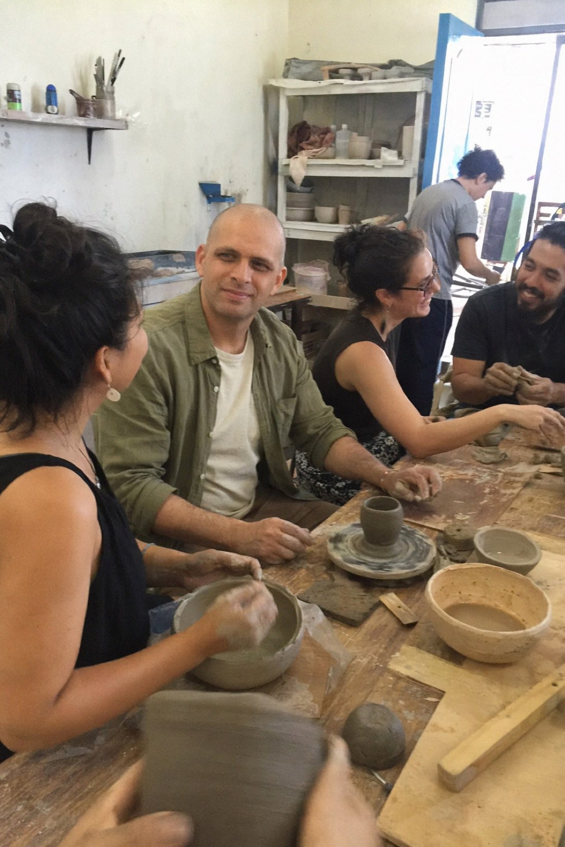AI photo of a man in a pottery workshop with other people