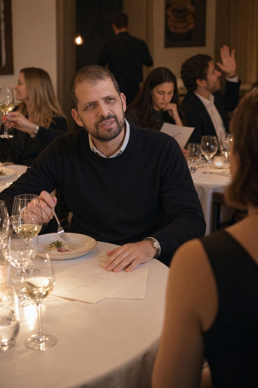 Man at a candlelit restaurant table across from his date, the format this article is defending