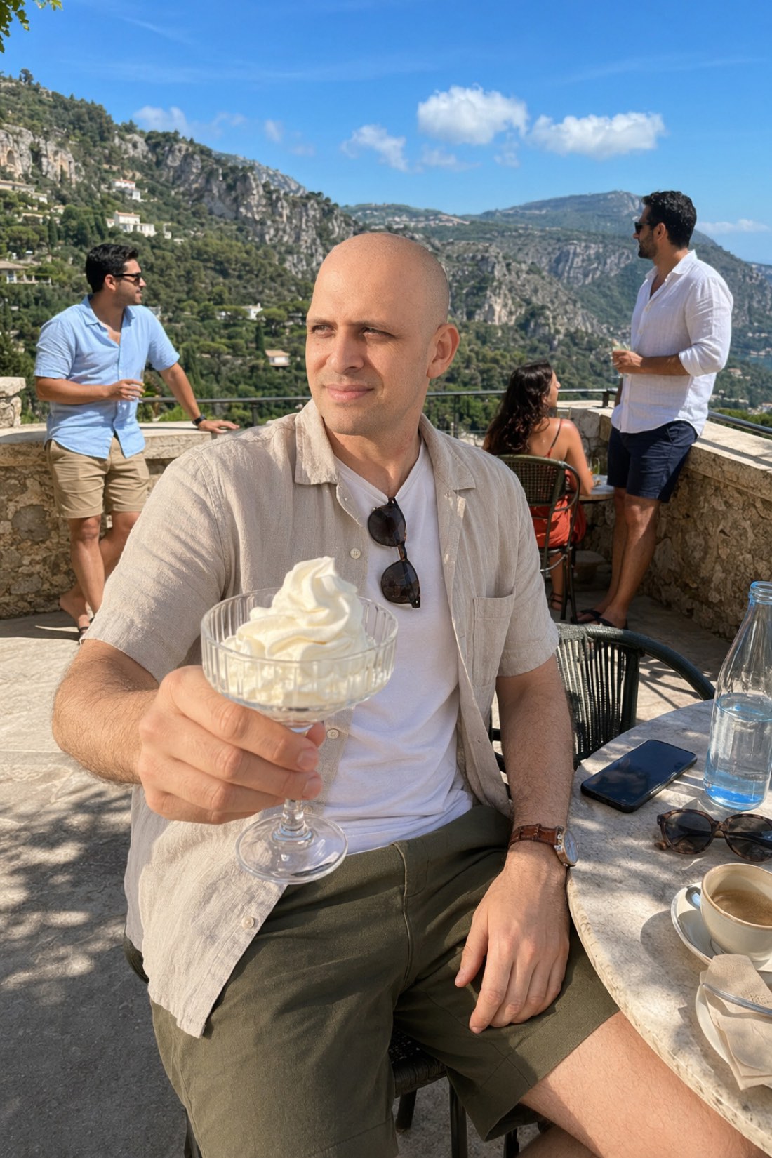 Man enjoying a sundae on a terrace date, relaxed enough to actually notice who is across the table