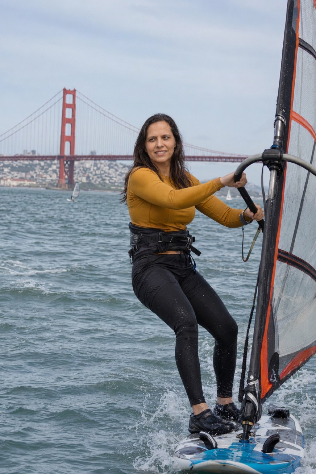 Woman windsurfing with the Golden Gate Bridge behind her, a full scene generated around her by AI