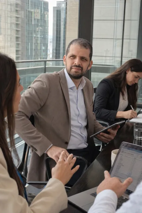 AI LinkedIn photo example: in a glass meeting room with colleagues